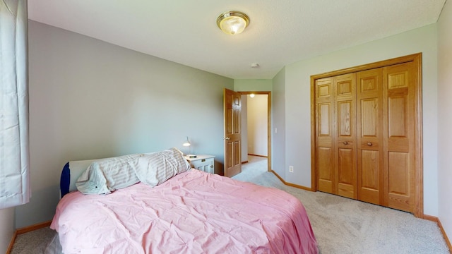 bedroom featuring a closet and light colored carpet