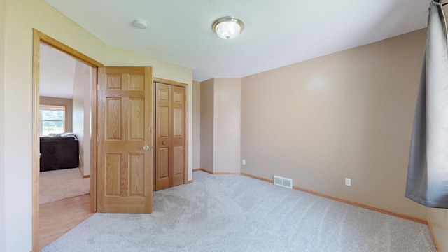 carpeted bedroom with a closet