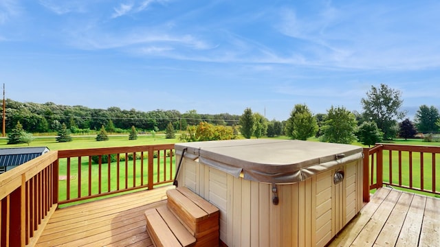 deck with a lawn and a hot tub