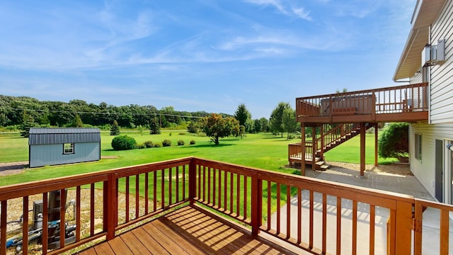 wooden deck with a storage shed and a lawn