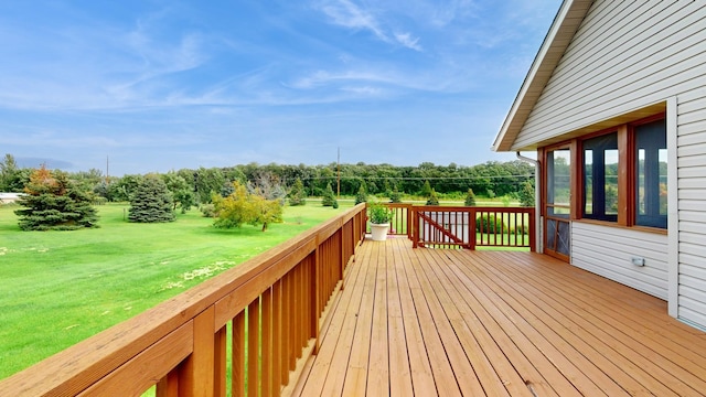 wooden terrace featuring a yard