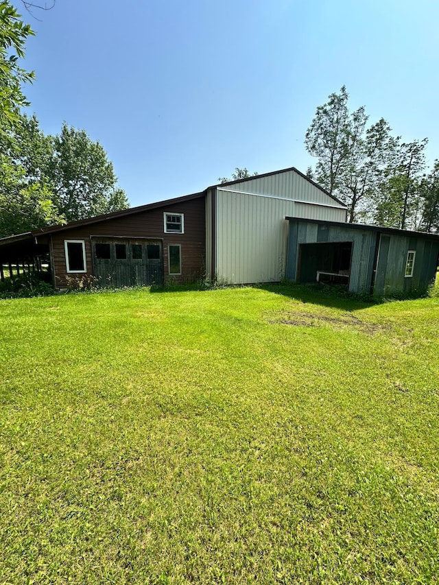 view of outdoor structure featuring a lawn