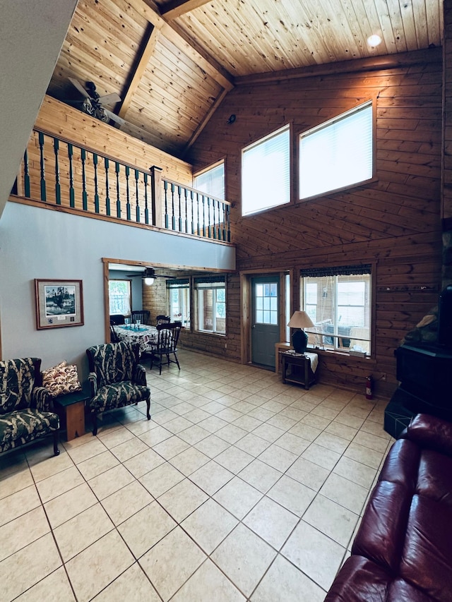 tiled living room with wood ceiling and lofted ceiling with beams