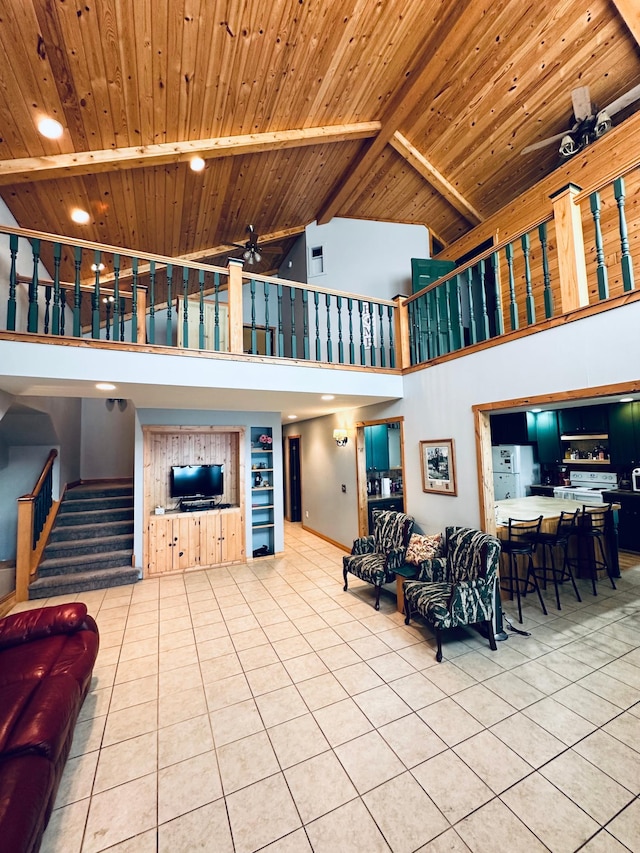 living room featuring ceiling fan, light tile patterned floors, wood ceiling, and beam ceiling