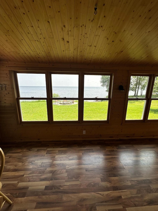 unfurnished sunroom with a water view and wood ceiling