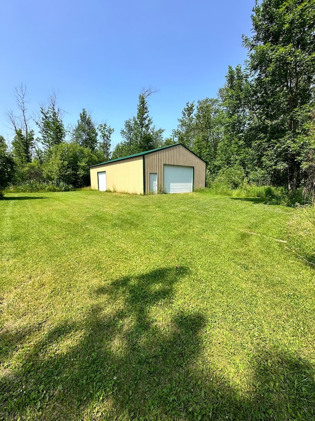 exterior space featuring a garage and a lawn