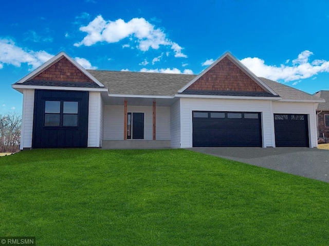 view of front of home featuring a garage and a front lawn