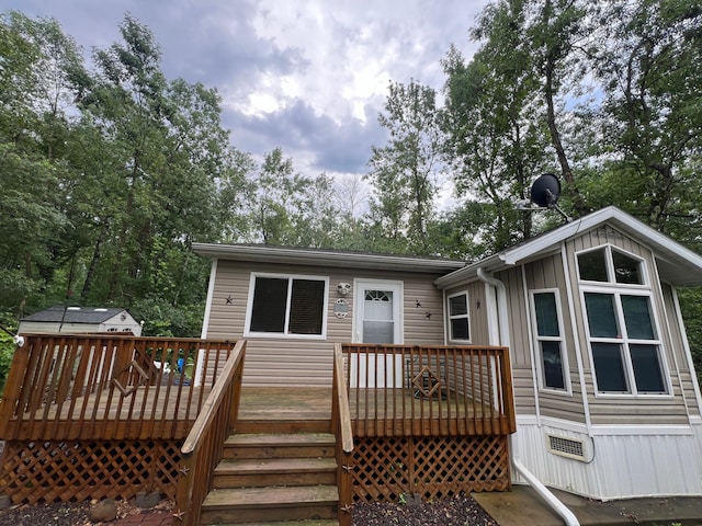 back of property with a wooden deck