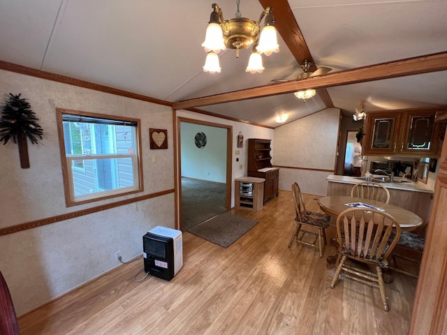 dining space featuring light hardwood / wood-style flooring, lofted ceiling with beams, ceiling fan with notable chandelier, and ornamental molding