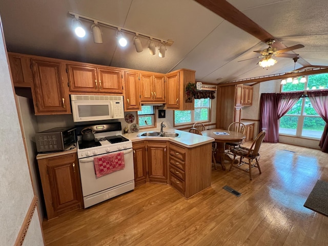 kitchen featuring lofted ceiling with beams, light hardwood / wood-style floors, plenty of natural light, white appliances, and ceiling fan