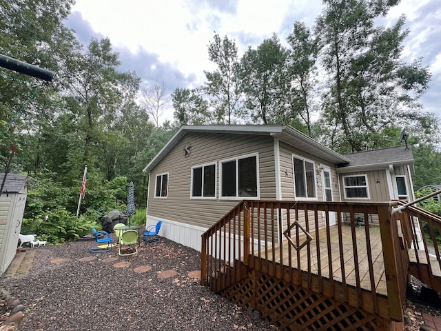 back of property featuring a wooden deck