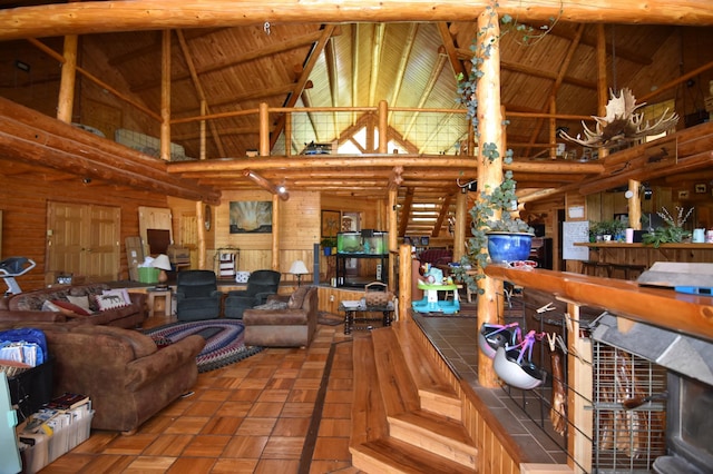 living room with wooden ceiling, wood walls, and high vaulted ceiling