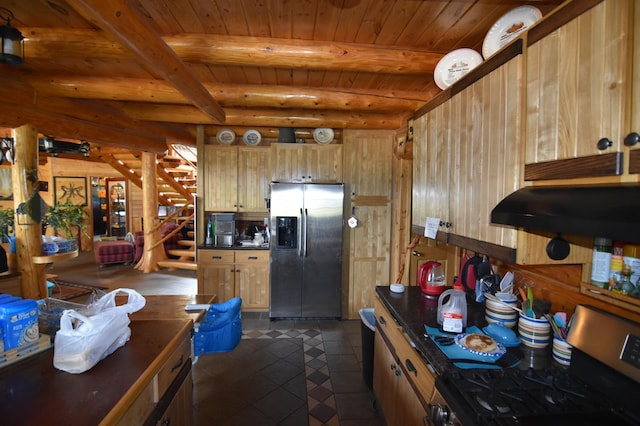 kitchen featuring stove, beamed ceiling, stainless steel fridge, wood ceiling, and dark tile patterned flooring