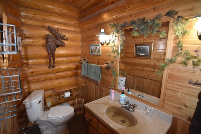 half bath with toilet, log walls, and vanity