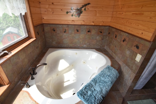 bathroom featuring wood walls and a whirlpool tub