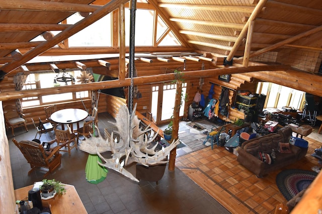 interior space featuring log walls, high vaulted ceiling, and wood ceiling