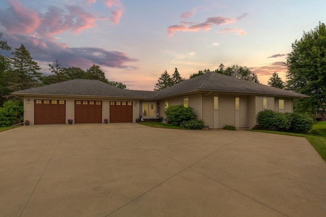 view of front of house with a garage and concrete driveway