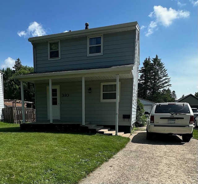 view of front facade featuring fence, a porch, and a front yard