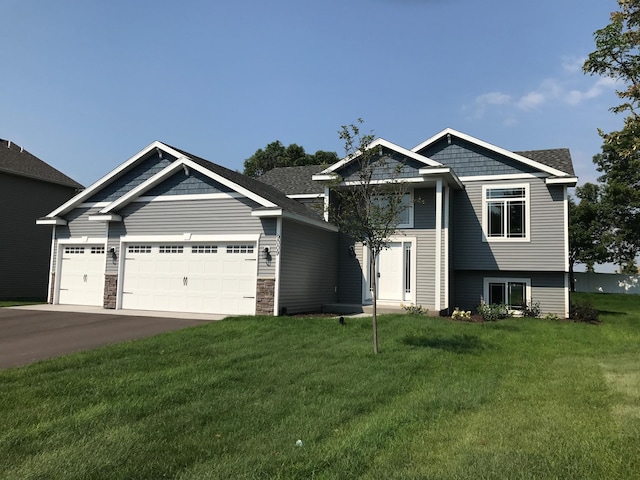 view of front of house with a garage and a front yard