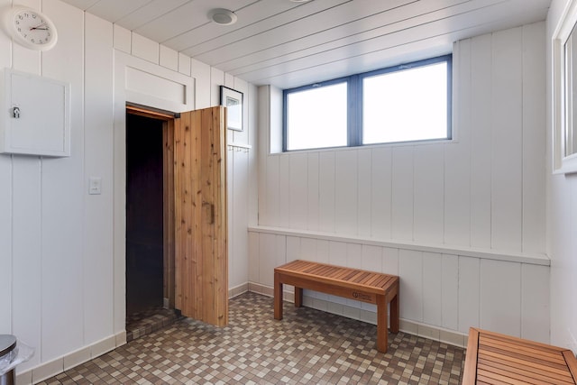 interior space featuring plenty of natural light and wooden walls
