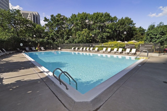 pool featuring a patio area and fence