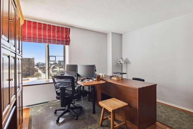 office featuring a textured ceiling and dark hardwood / wood-style flooring