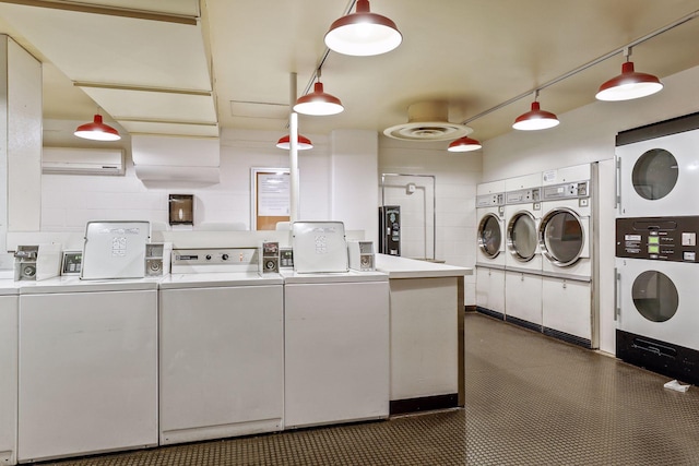 shared laundry area with washer and clothes dryer and an AC wall unit