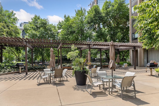 view of patio with a pergola, fence, and outdoor dining area