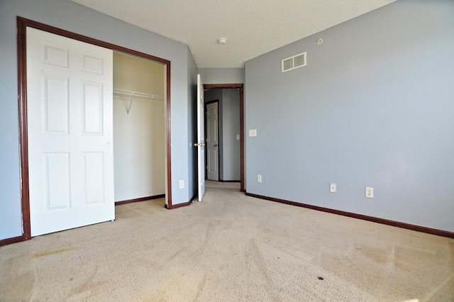 unfurnished bedroom featuring a closet and carpet floors