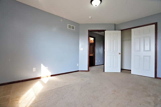 unfurnished bedroom featuring a closet and carpet flooring