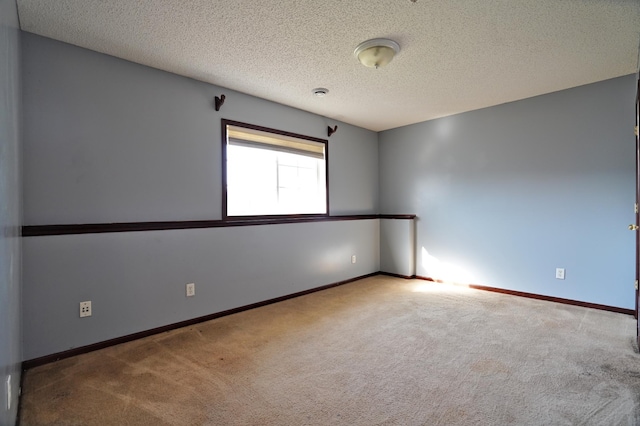 unfurnished room featuring carpet floors and a textured ceiling