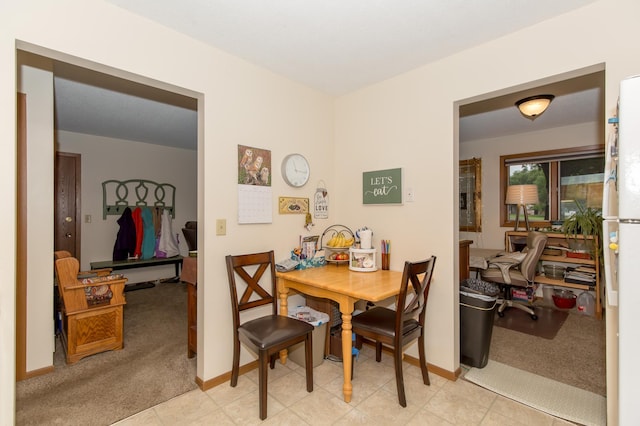 dining space with light carpet