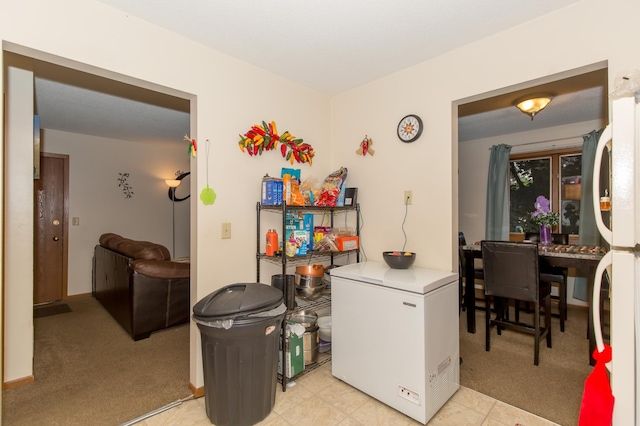 washroom featuring stacked washer and clothes dryer and light carpet