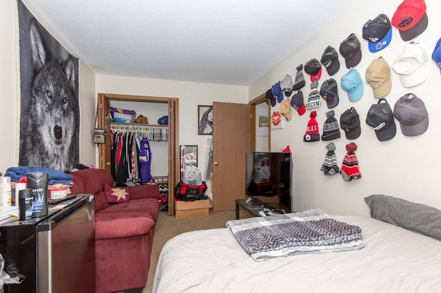 carpeted bedroom featuring stainless steel fridge and a closet