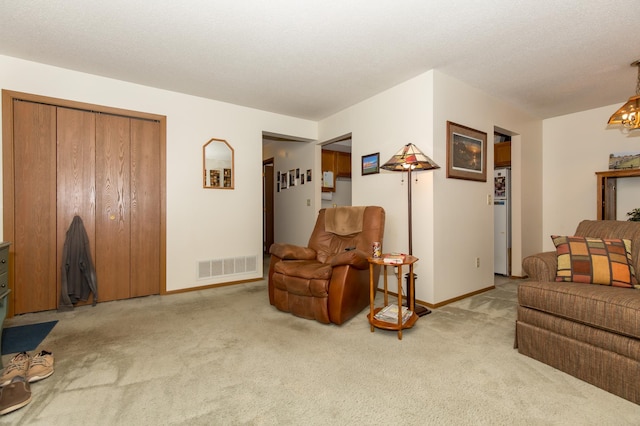 living room with light colored carpet and a textured ceiling