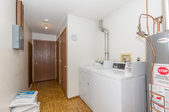 washroom with water heater, light parquet floors, electric panel, washing machine and clothes dryer, and a textured ceiling