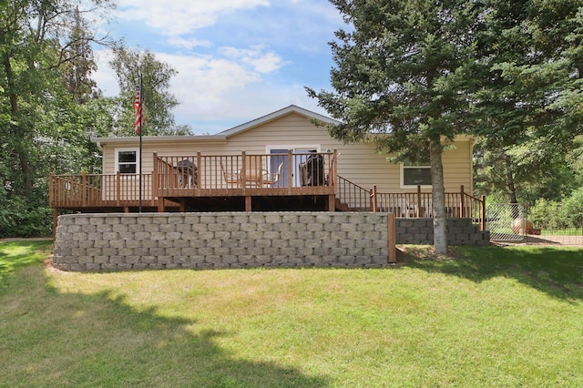 back of house with a lawn and a wooden deck