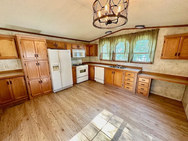 kitchen with a notable chandelier, sink, white appliances, and light wood-type flooring