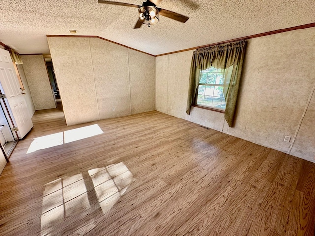 unfurnished bedroom with crown molding, light wood-type flooring, and a textured ceiling