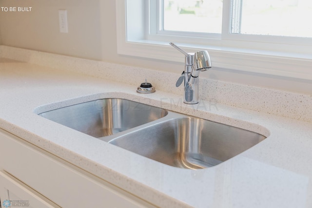 details with sink and light stone countertops