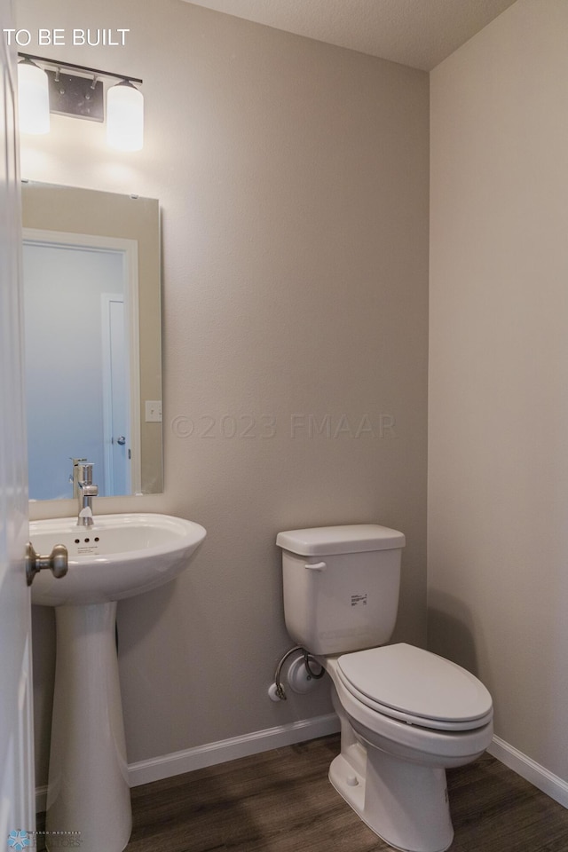 bathroom with wood-type flooring and toilet