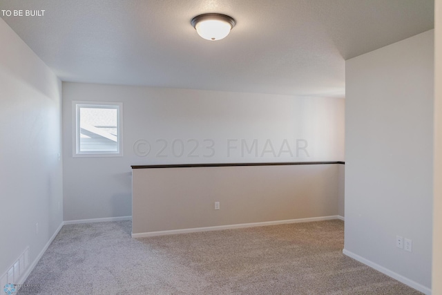 empty room featuring light carpet