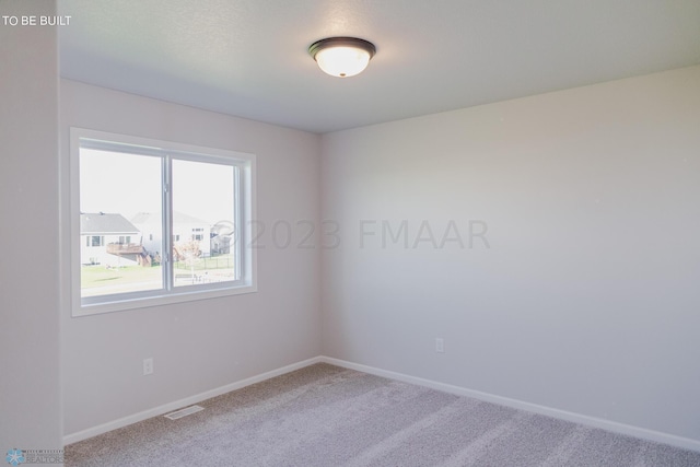 unfurnished room featuring carpet floors