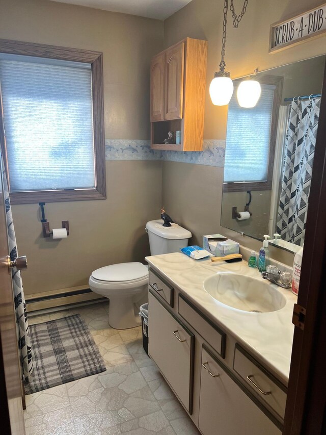 618 Memorial Pl, Dawson, MN 56232 - bathroom featuring healthy amount of natural light, a baseboard heating unit, toilet, and vanity