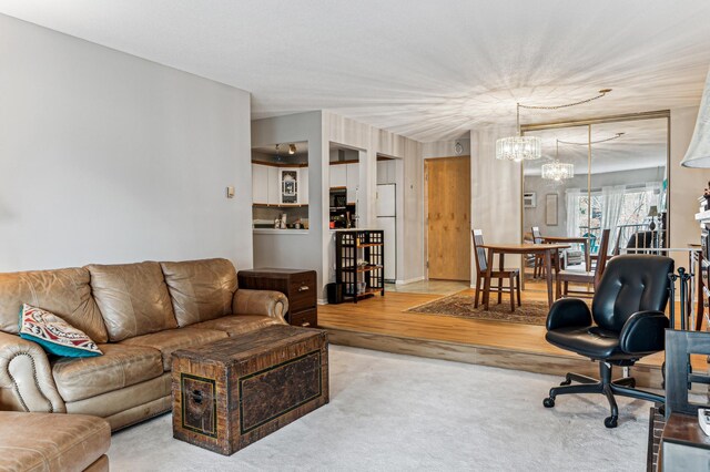 living room featuring light hardwood / wood-style flooring and a chandelier