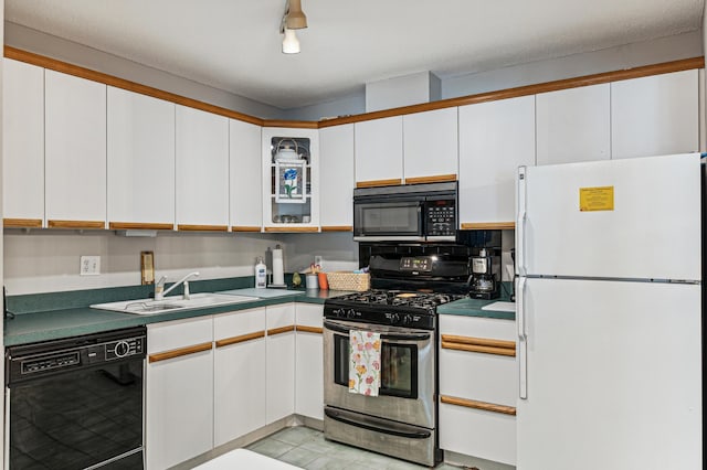 kitchen with dark countertops, white cabinets, and black appliances