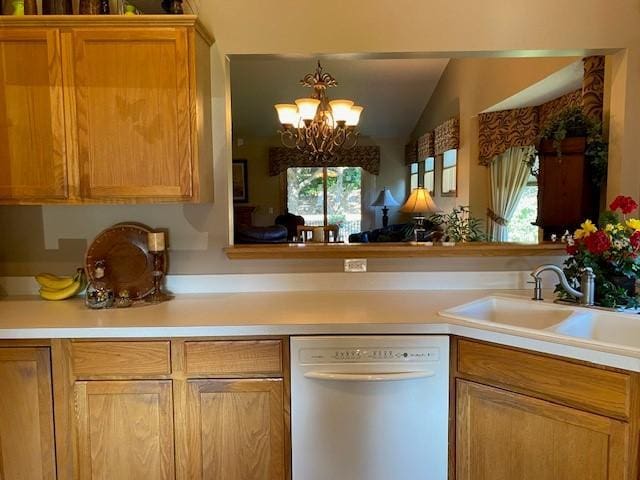 kitchen featuring a sink, dishwasher, vaulted ceiling, and light countertops