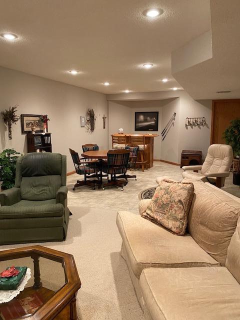 living room with recessed lighting, baseboards, and carpet