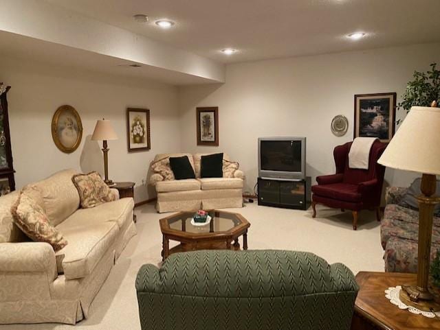 living area featuring recessed lighting and light carpet