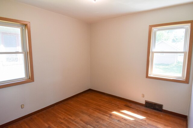 spare room with hardwood / wood-style flooring